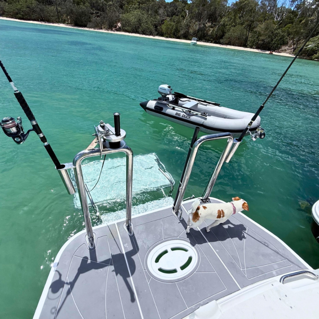 A boat transom featuring the Aquatenderdeck lowered into the water to act as a submerged swim platform